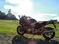 Motocykl na tle zamku w skale. Idealny kompan na podróż po Jurze Krakowsko-Częstochowskiej.