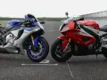 Dwa sportowe motocykle: niebiesko-srebrny Yamaha R1 i czerwono-biały BMW S1000RR 2020, stojące na torze wyścigowym.