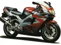 Sportowy motocykl Kawasaki ZX9R w czerwono-srebrnej kolorystyce, gotowy do jazdy.