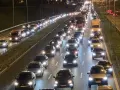 Nocny korek na drodze S8. Długi sznur samochodów i ciężarówek z zapalonymi światłami tworzy świetlisty tunel.