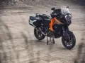 Pomarańczowo-czarny motocykl KTM 1290 Super Adventure z kuframi, gotowy na każdą wyprawę.