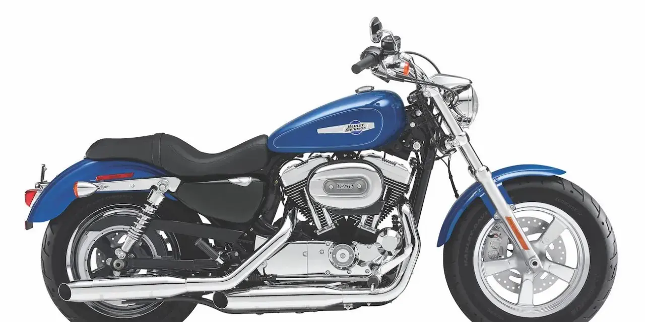 Błękitny motocykl Harley Sportster 1200 z chromowanymi elementami, gotowy na drogę.