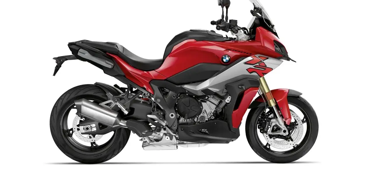 Czerwony motocykl sportowo-turystyczny BMW XR z szarymi akcentami i czarnym siedzeniem, gotowy na przygodę.