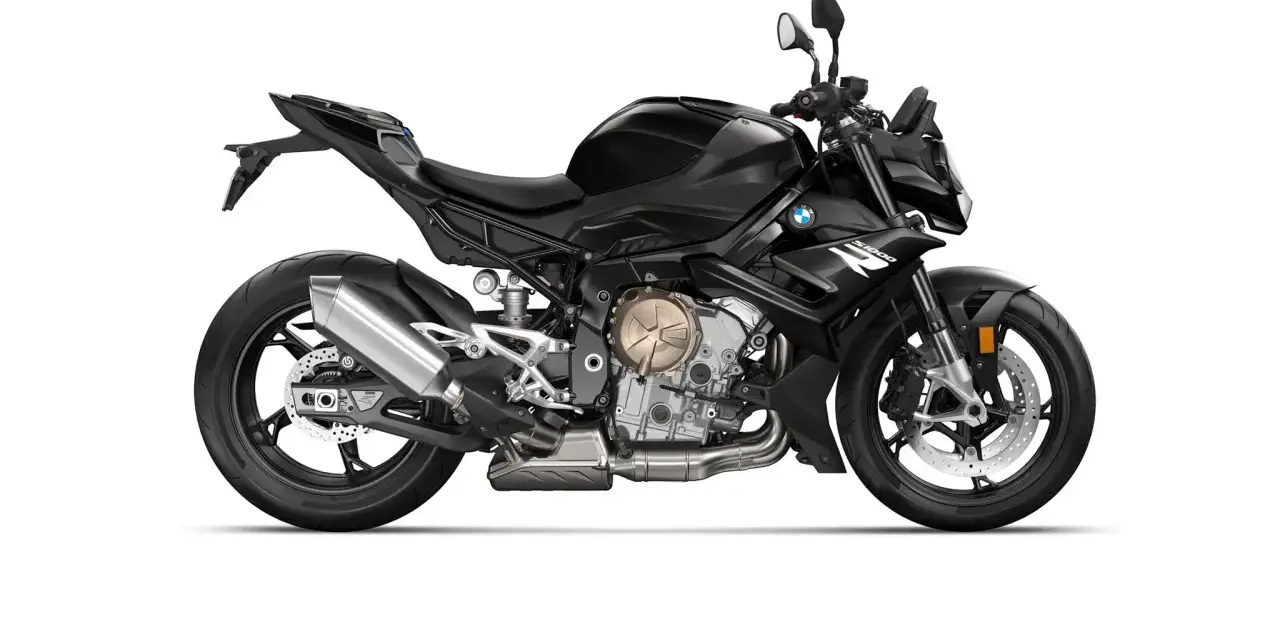 Czarny motocykl BMW S1000R z wydechem Akrapovič i złotymi elementami silnika. Gotowy do jazdy po mieście i torze.