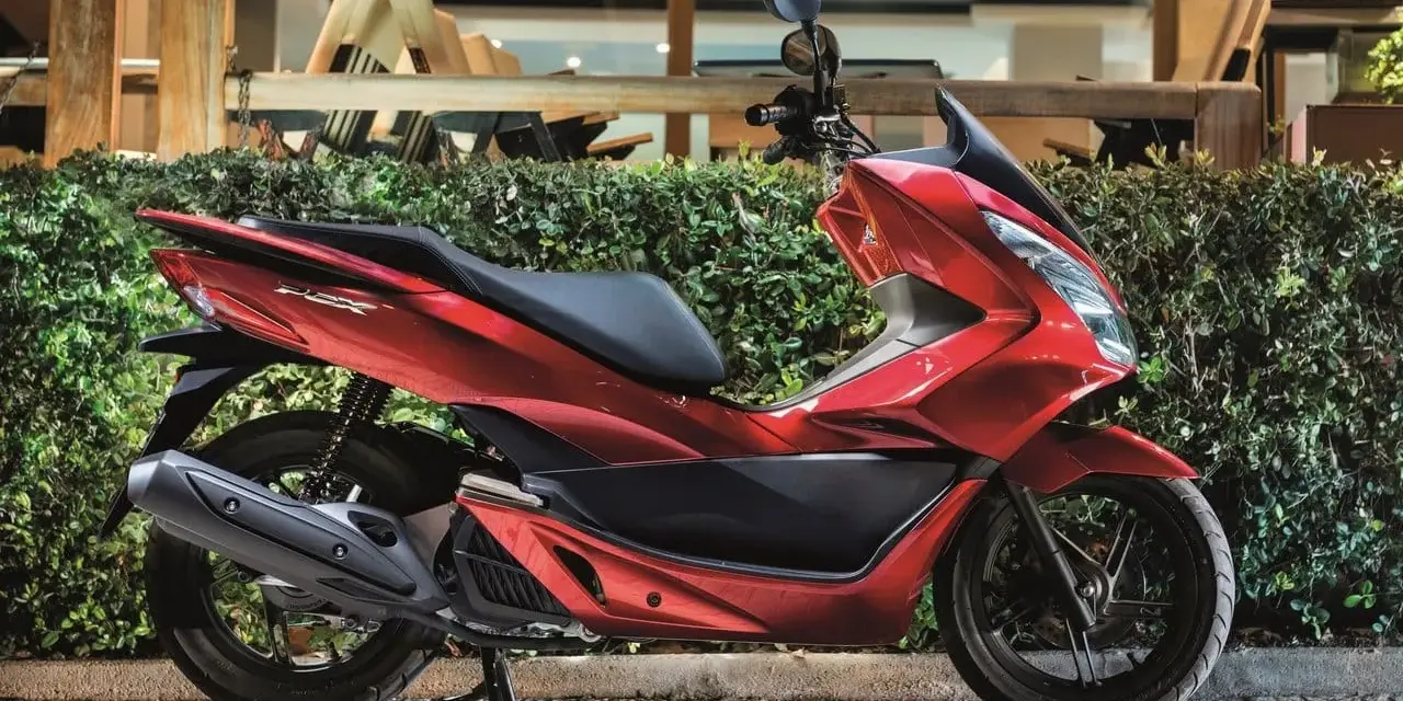 Lśniący czerwony skuter 125, idealny na 15 km dojazdy do pracy. Elegancki design i komfortowa jazda.