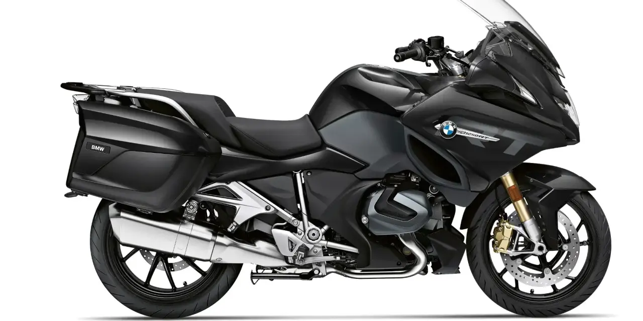 Czarny motocykl turystyczny BMW R 1250 RT z kuframi, gotowy na dalekie podróże.
