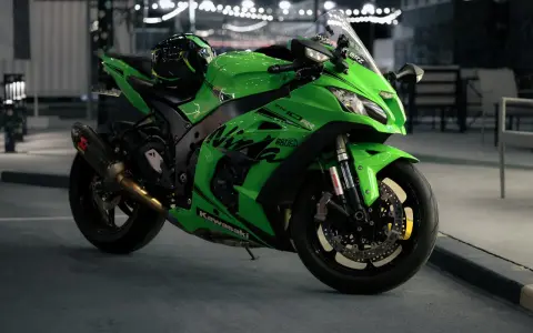 Japoński motocykl Kawasaki Ninja ZX-10R w jaskrawym zielonym kolorze, gotowy do nocnej jazdy.