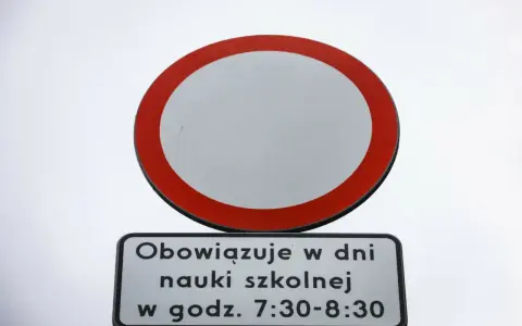 Znak b1 zakazu wjazdu, z tabliczką "Obowiązuje w dni nauki szkolnej w godz. 7:30-8:30".