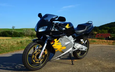 Czarny motocykl Honda NSR 125 z żółtymi akcentami, idealny do poznania jego honda nsr 125 dane techniczne.