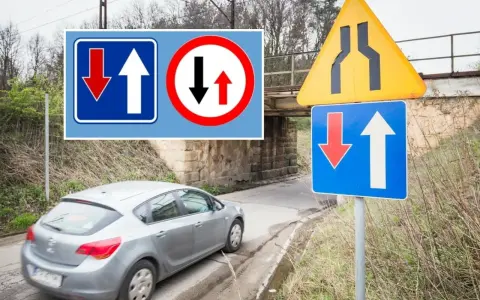 Znaki drogowe informują o pierwszeństwie na zwężonym odcinku jezdni. Samochód zbliża się do miejsca, gdzie ruch jest utrudniony.