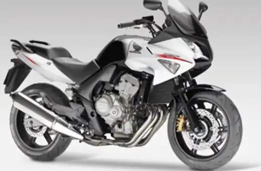 Sportowy motocykl Honda CBF 600 w kolorze biało-czarnym. Jego waga jest optymalna do zwinnego manewrowania.