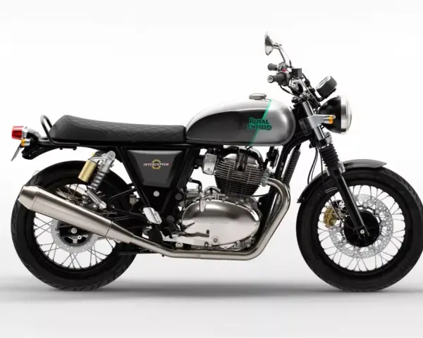 Stylowy Royal Enfield Interceptor 650 w kolorze szaro-zielonym, z chromowanym silnikiem i czarnym, pikowanym siedzeniem, gotowy na każdą podróż.
