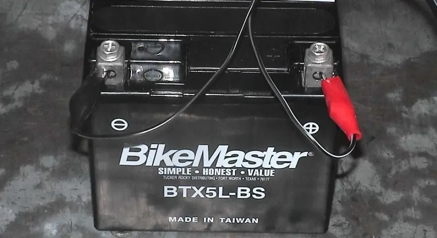 Akumulator motocyklowy BikeMaster BTX5L-BS podłączony do ładowarki. Zastanawiasz się, jakim prądem ładować akumulator? Sprawdź instrukcję.