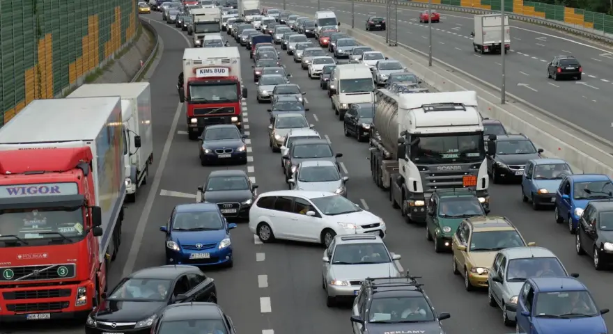 Korki na autostradzie, wiele samochodów i ciężarówek stoi w miejscu. Aktualne utrudnienia na drogach uniemożliwiają płynny ruch.