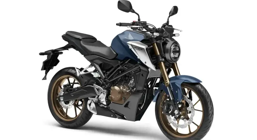 Niebieski motocykl Honda CB125R, uznawany za najmocniejszy motocykl 125, z brązowymi felgami i nowoczesnym designem.