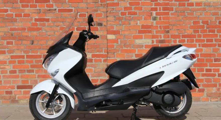 Biały skuter Suzuki Burgman 125, idealny do miasta. Zastanawiasz się nad jego spalaniem? Ten model słynie z oszczędności.