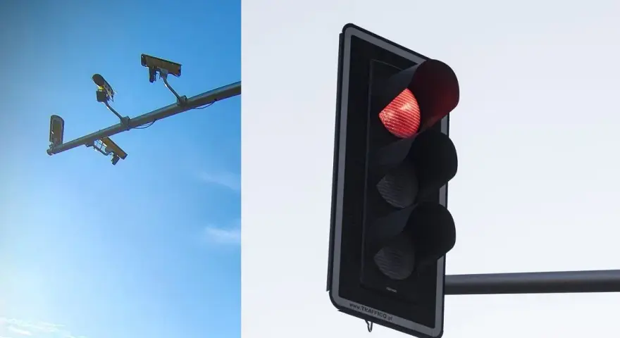 System red light zatrzymuje ruch. Po lewej kamery monitorujące, po prawej czerwone światło sygnalizatora.