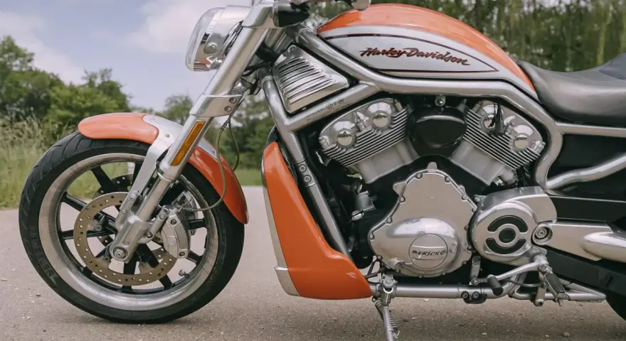 Pomarańczowy Harley-Davidson z serii V-Rod, potężny muscle bike, gotowy na jazdę.