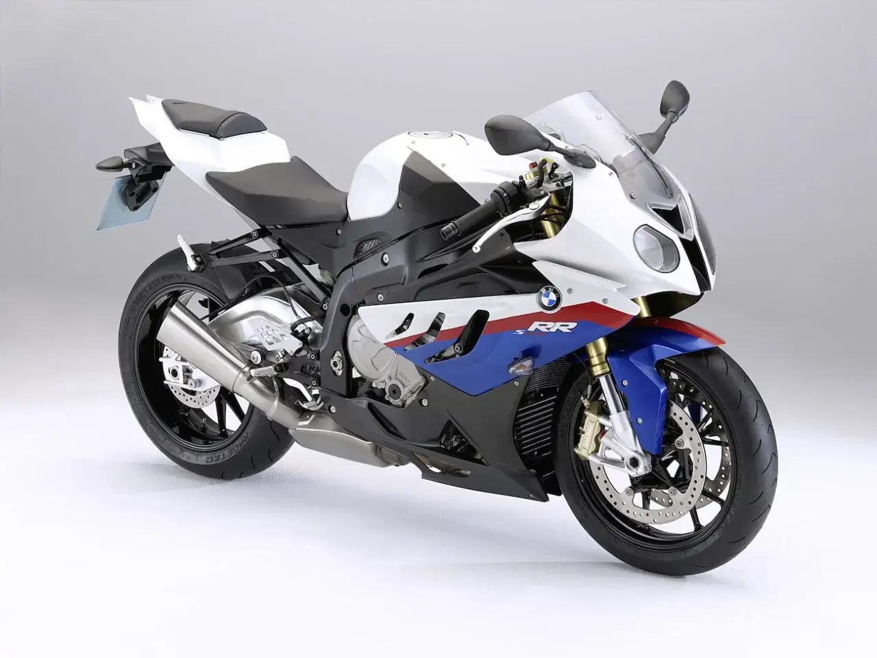 Sportowy motocykl BMW S1000RR 2018 w biało-niebiesko-czerwonych barwach, gotowy do podboju toru.